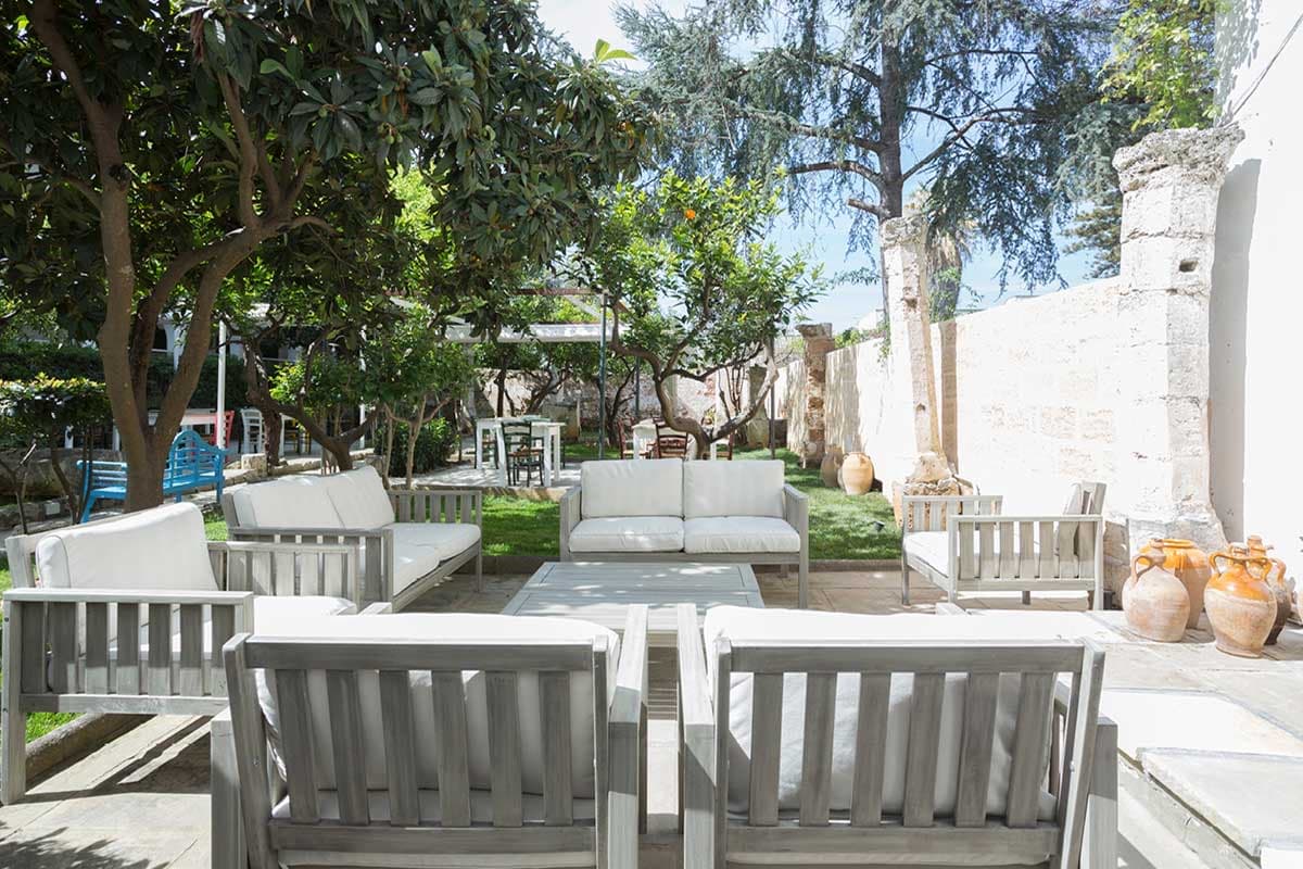 Il giardino con divanetti all'ombra degli alberi